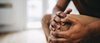 hands holding a knee
